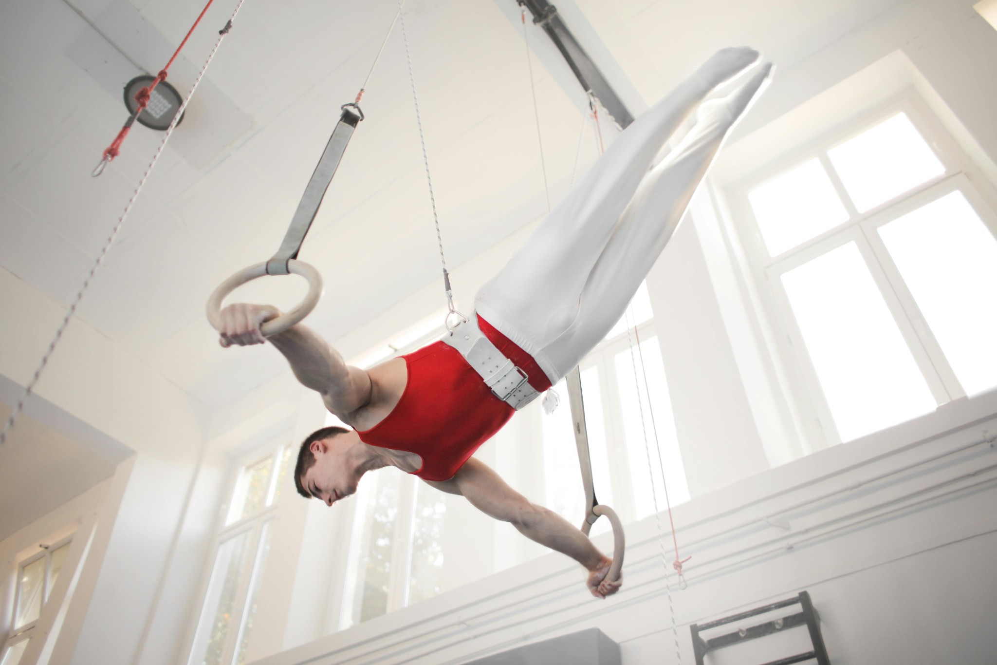 Professional gymnast performing on still rings